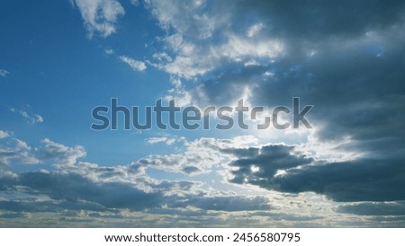 Beautiful blue sky with sunbeams and clouds. Clouds at blue sky background. Sunny cloudscape. Timelapse.