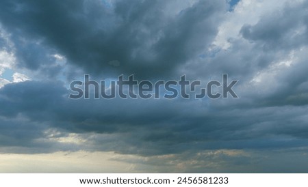 Heavy rain is coming. Cumulus dark clouds harbinger of bad weather and heavy rains. Timelapse. Royalty-Free Stock Photo #2456581233