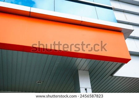 Orange signboard mockup in outside for logo design, brand presentation for companies, ad and advertising