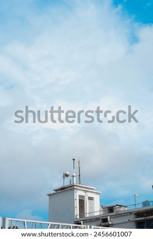 Exterior architecture background, stairway to rooftop of white building against blue sky. Portrait photo