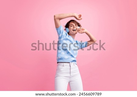 Photo of lovely cheerful person closed eyes listen favorite song dancing rejoice isolated on pink color background
