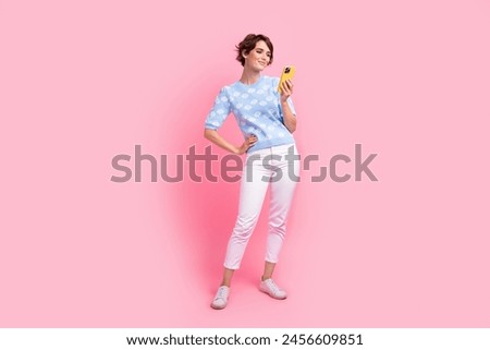 Full length photo of lovely nice person use smart phone typing blog post isolated on pink color background