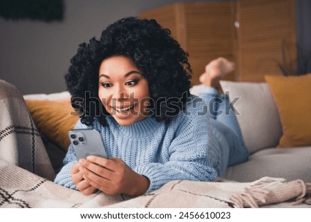 Full size photo of nice young woman use smart phone wear blue sweater modern interior apartment indoors