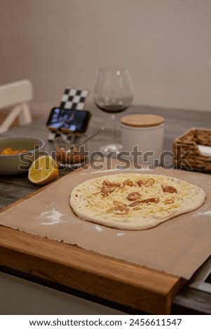 Pizza dough, movie evening, red wine, lemon, recipe, homemade pizza, cheese, sauce Royalty-Free Stock Photo #2456611547