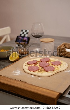 Pizza dough, movie evening, red wine, lemon, recipe, homemade pizza, cheese, sauce, salami Royalty-Free Stock Photo #2456612269