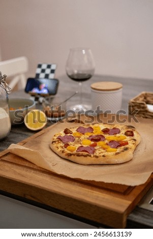 Pizza dough, movie evening, red wine, lemon, recipe, homemade pizza, cheese, sauce, salami, cherry tomatos Royalty-Free Stock Photo #2456613139