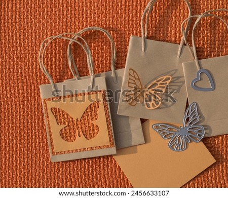 paper bag decorated with cut-out butterflies. Conceptual photo to announce spring shopping. Cardboard crafts.