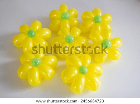 yellow daisies from balloons on a white background