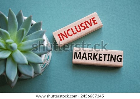 Inclusive Marketing symbol. Wooden blocks with words Inclusive Marketing. Beautiful grey green background with succulent plant. Business and Inclusive Marketing concept. Copy space.