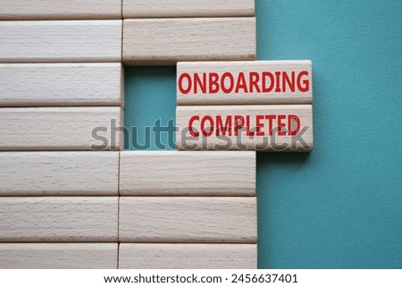 Onboarding Completed symbol. Concept word Onboarding Completed on wooden blocks. Beautiful grey green background. Business and Onboarding Completed concept. Copy space