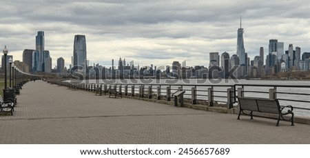 view of walking biking pedestrian cycling path trail in liberty state park with view of downtown manhattan skyline in background (travel destination public green space) jersey city syscrapers urban