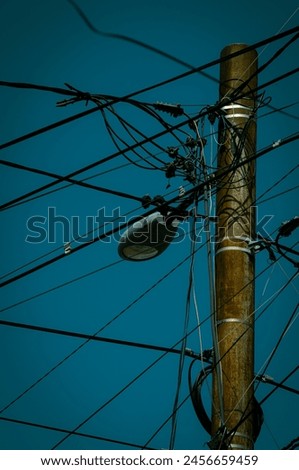 Street lamp and cables with blue sky. Royalty-Free Stock Photo #2456659459