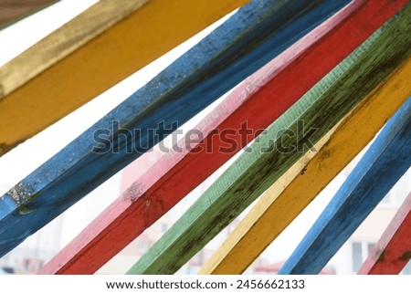 A group of multicolored wooden boards stacked on top of each other, creating a vibrant visual arrangement. Royalty-Free Stock Photo #2456662133