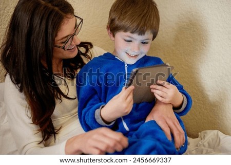 Happy mother, child and tablet in home bedroom for learning, education and storytelling with boy. Mom, kid and digital tech on bed for game, relax or family streaming cartoon on internet together