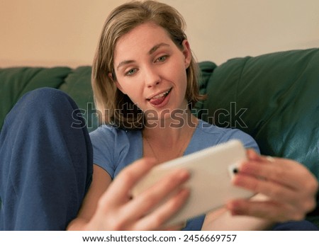 Funny face, woman and selfie on sofa in home for social media, goofy memory and post online. Photography, picture and girl with tongue out for comic, comedy emoji or crazy influencer in living room