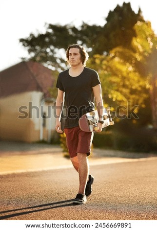 Skateboard, outdoor and young man walking in street for skating, hobby or skill training in neighbourhood. Skater, confident and teenager for extreme sports, balance or recreation activity on weekend