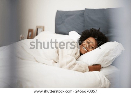 African, woman relax and bed in home, blanket and comfort on weekend morning for rest and wellness. Happy, smile and awake feeling positive or calm and peace, lazy Sunday and bedroom in apartment Royalty-Free Stock Photo #2456670857