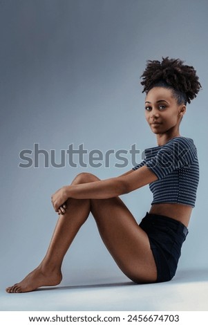 Relaxed and poised, she offers a calm, approachable demeanor in her outfit Royalty-Free Stock Photo #2456674703