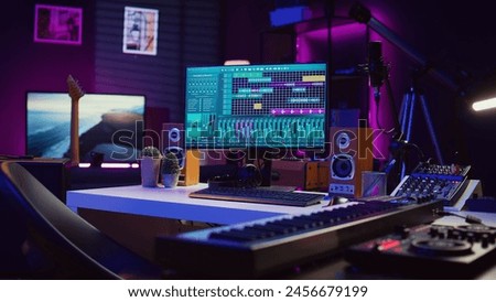 Empty studio at home equipped with mixing soundboard panel and other musical instruments, music industry recording. Modern space with electronic controls and daw software on pc. Camera B.