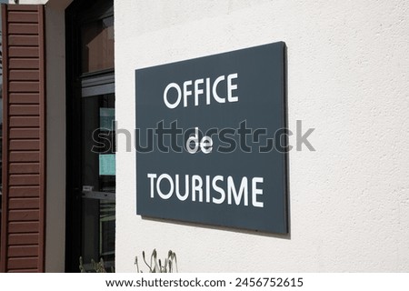 office de tourisme text French means tourism office on wall sign building facade entrance in France