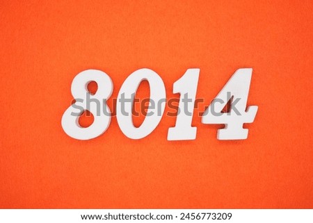 The number 8014 is made from white painted wood placed on a background of orange paper.