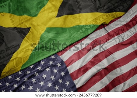 waving colorful flag of united states of america and national flag of jamaica. macro