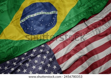 waving colorful flag of united states of america and national flag of brazil on the dollar money background. finance concept. macro