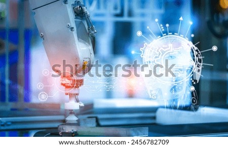 Robot hand machine control by AI in manufacturing industry. AI-powered automation. Automatic robotic arm in factory. AI-controlled for intelligent manufacturing. AI-driven automation. Sovereign AI. Royalty-Free Stock Photo #2456782709