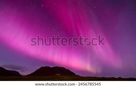 Pink Aurora, sky and mountains, fantastic Royalty-Free Stock Photo #2456785545