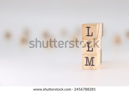 Abbreviation LLM. Cocept of Large Language Model written on wooden cubes isolated on white background. Royalty-Free Stock Photo #2456788281