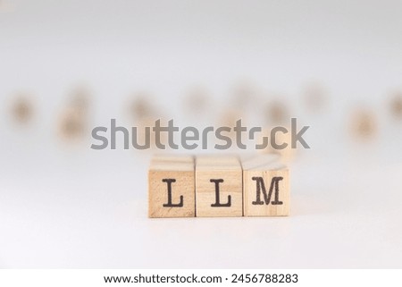 Abbreviation LLM. Cocept of Large Language Model written on wooden cubes isolated on white background. Royalty-Free Stock Photo #2456788283