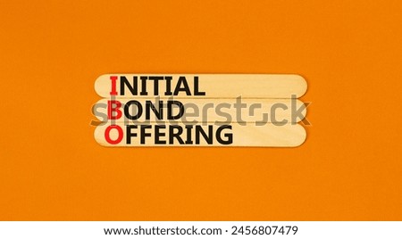 IBO initial bond offering symbol. Concept words IBO initial bond offering on beautiful wooden stick. Beautiful orange background. Business IBO initial bond offering concept. Copy space.