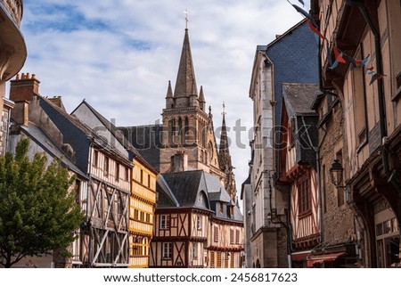 View of the typical Breton houses and in the background the Cathedral Basilica of Saint Peter appears. Photography taken in Vannes, Brittany, France.