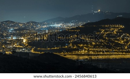 Night Timelapse of Barcelona and Badalona Skylines. Aerial View from Iberic Puig Castellar Village Viewpoint, Roofs of Houses, with Tibidabo on the Horizon, Illuminated Under the Starlit Night Sky