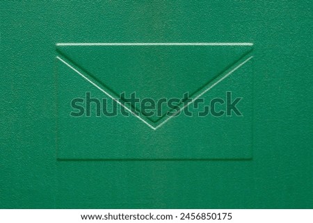 Letter sign on a green metal background