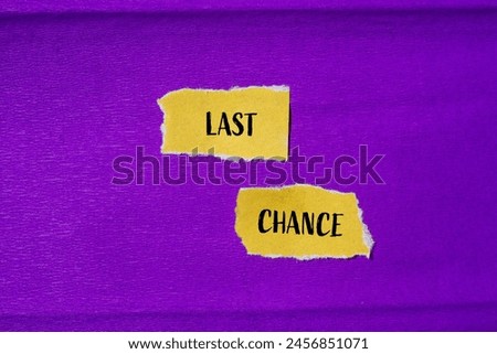 Last chance words written on ripped yellow paper pieces with purple background. Conceptual last chance symbol. Copy space.