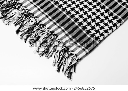 A traditional pattern head-tied garment 'Keffiyeh' or 'Puşi' on a white isolated background. Keffiyeh is widely used in the Middle East and the Arab World.