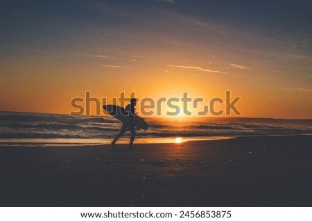 Beach Picture with Sun set and human with hasst board