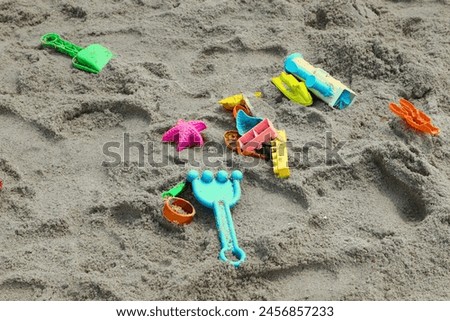 travel photography of beach plastic toys on sand during summer school holiday in Jakarta beach park