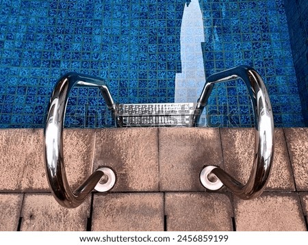 travel photography of swimming pool with stainless steel ladders for summer activity