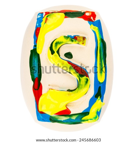 Handmade of white clay letter S painted with colorful acrylic paints isolated on white