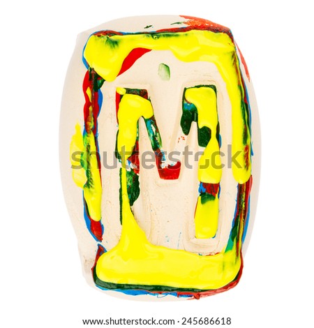 Handmade of white clay letter M painted with colorful acrylic paints isolated on white