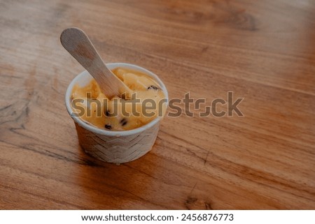Yellow Italian ice cream on a wooden table