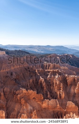 Cedar Breaks National Monument in Utah. A natural amphitheater filled with hoodoos, windows, canyons, spires, walls, and steep cliffs. A veiw from the canyon rim. Brian Head Peak in distance.  Royalty-Free Stock Photo #2456893891