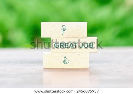BUSINESS CONCEPT. Great job on wooden blocks in front of a green background of green leaves out of focus