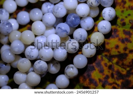 Beads of natural white dendric opal.