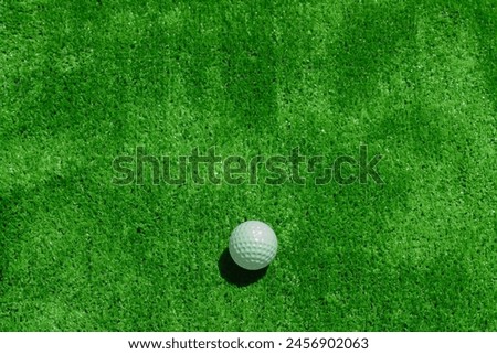 Golf ball on the green background