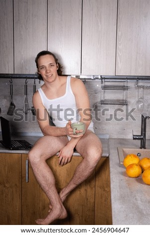 A young attractive guy in the kitchen is preparing a healthy lunch.