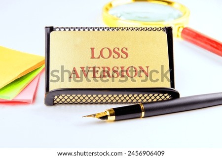 Business concept. The inscription Loss Aversion on the golden card Royalty-Free Stock Photo #2456906409