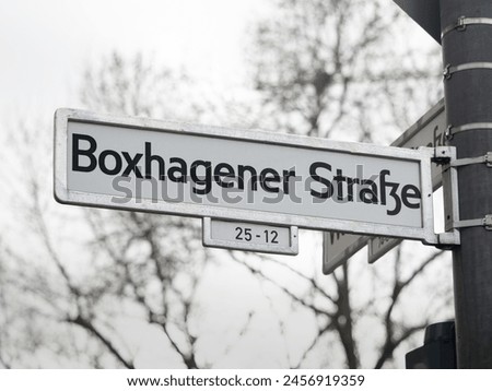 Boxhagener Straße street sign in Berlin. Road name guide at an intersection. The location is in the popular district Friedrichshain and a travel destination for many young tourists.